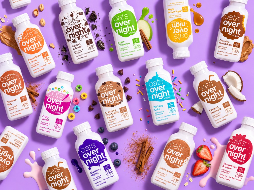 Oats Overnight retail shake bottles arranged on a purple background with flavor ingredients