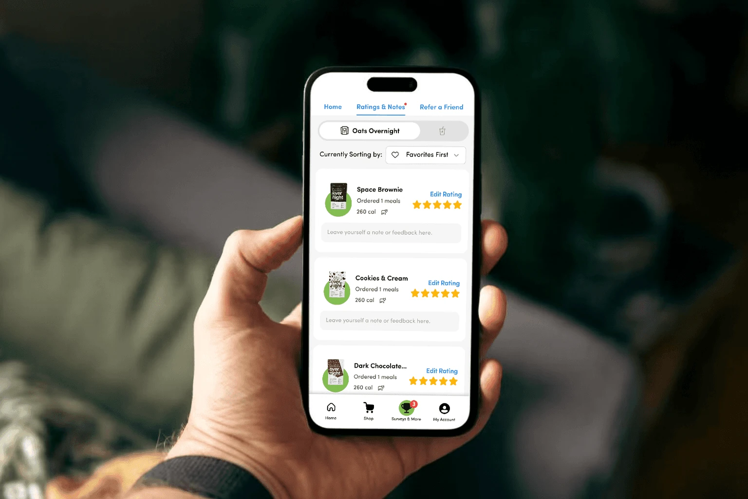 A customer holding a phone displaying flavor ratings and notes